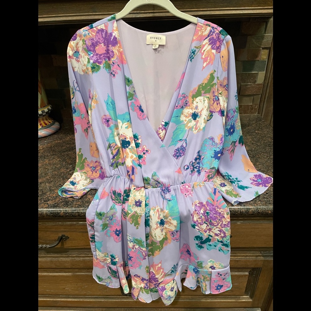 Purple floral romper size S- worn 1 time ! Bell sleeve and ruffle around shorts